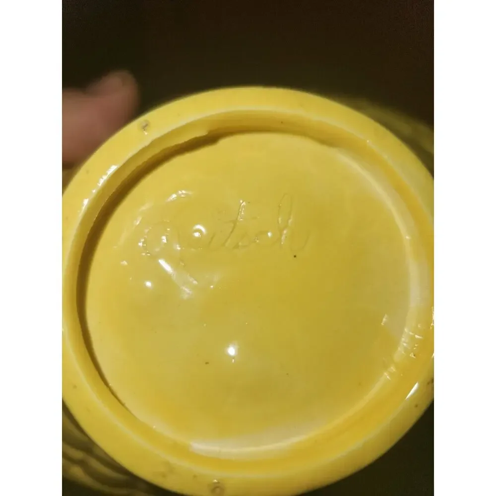yellow ceramic basket has Leitsch on bottom